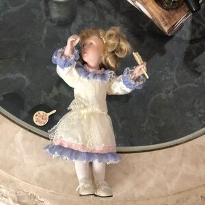 Elegant Porcelain Doll with Cream and Purple Dress